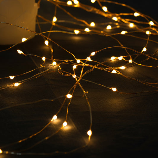 String of small lights on a yellow background
