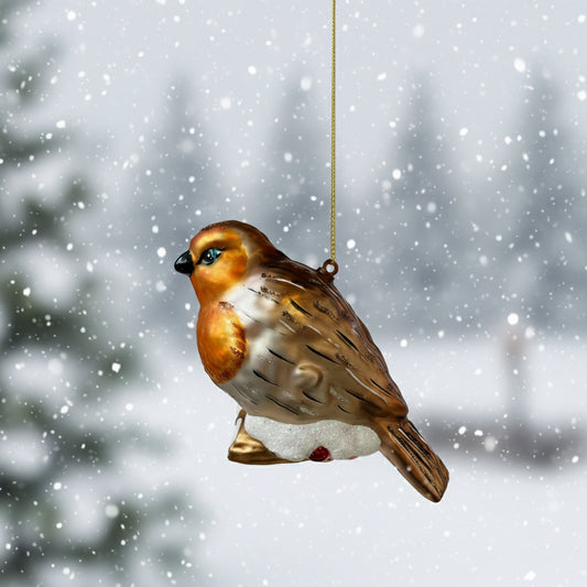 Glass ornament of a bird with brown, white, and black colors on a white background