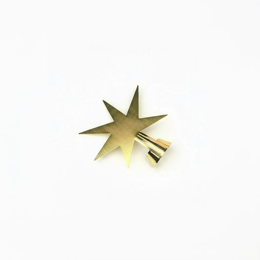 Gold star-shaped object on a white background