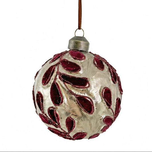 Decorative glass ball ornament with red patterns on a white background