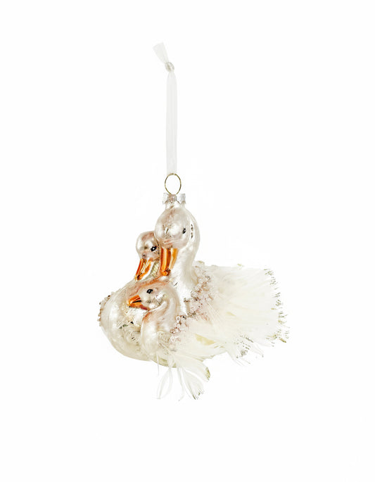 Decorative glass ornament of two swans on a white background