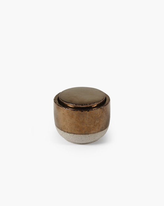 Bronze-colored cylindrical object on a white background