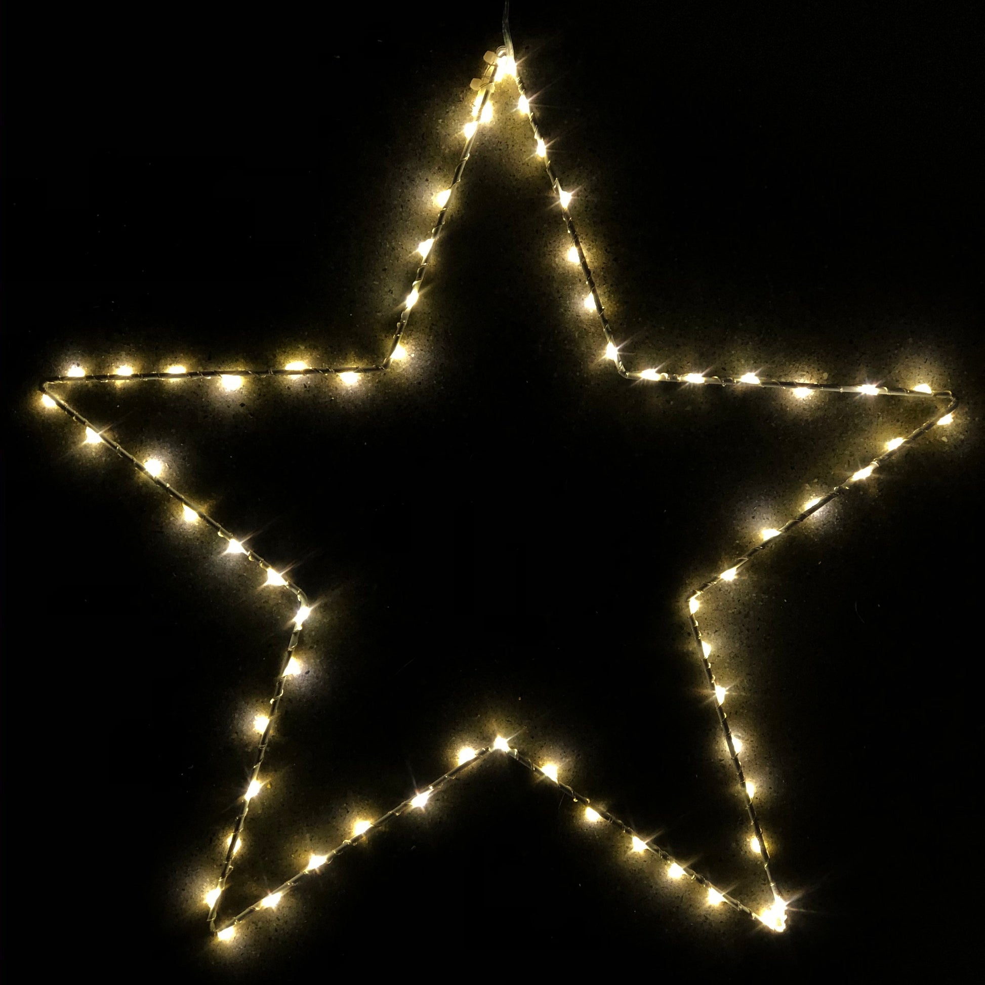 Star-shaped light decoration on a black background