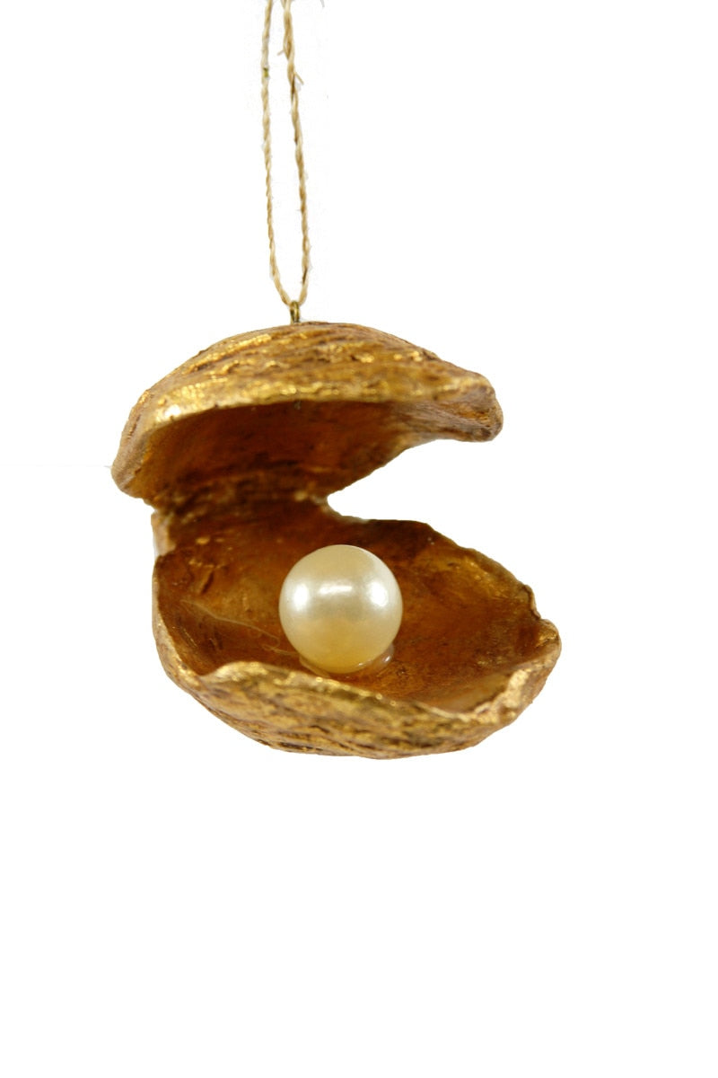 Decorative ornament of an open shell with a pearl inside on a white background
