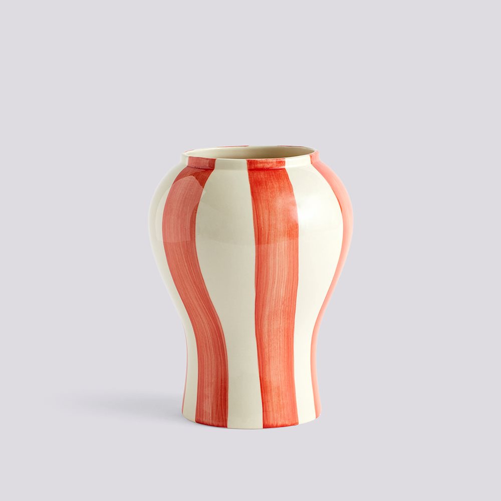 Vase with red and white striped pattern on a light gray background