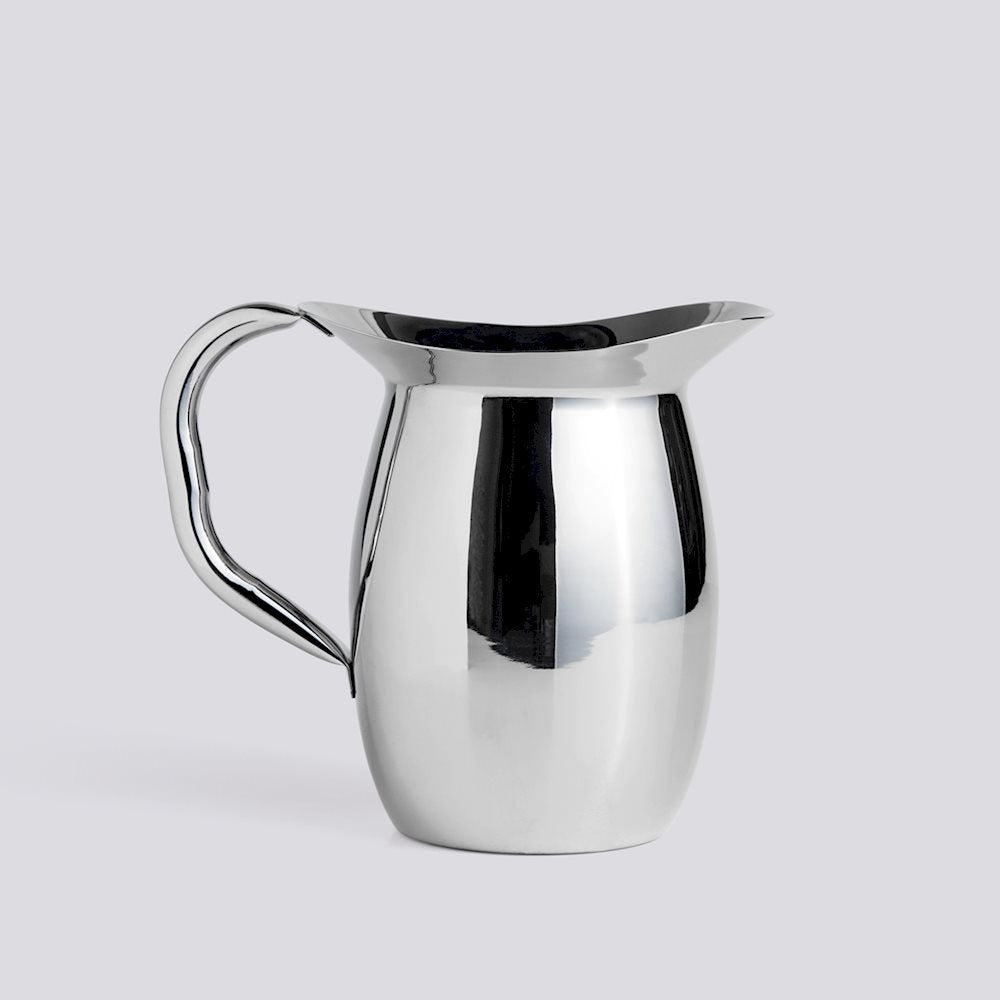Silver pitcher on a light gray background