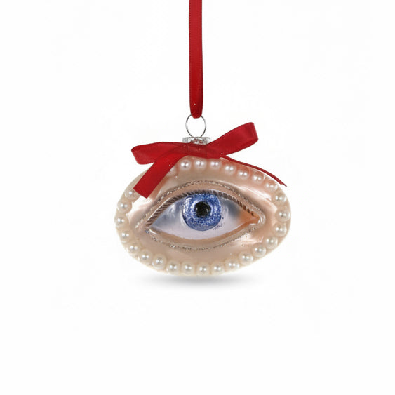 Decorative eye ornament with pearls and a red ribbon on a white background