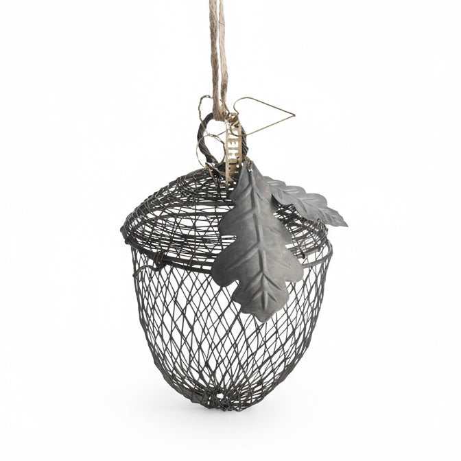 Decorative hanging bird feeder with a leaf on a white background