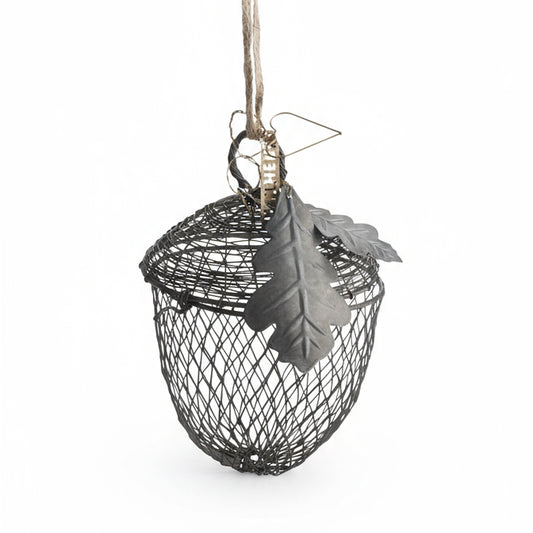 Decorative hanging bird feeder with a leaf on a white background