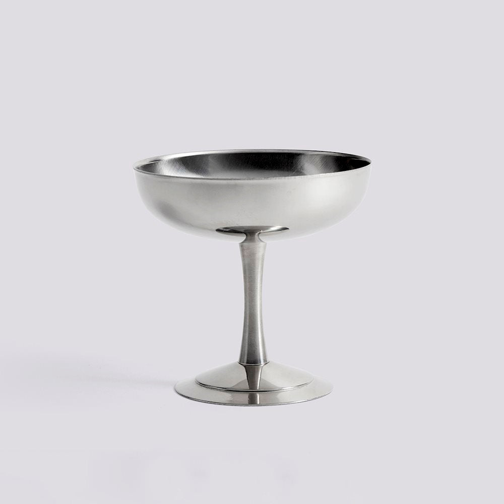 Silver metal cocktail coupe on a light gray background