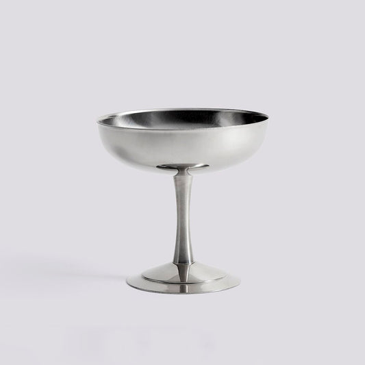 Silver metal cocktail coupe on a light gray background