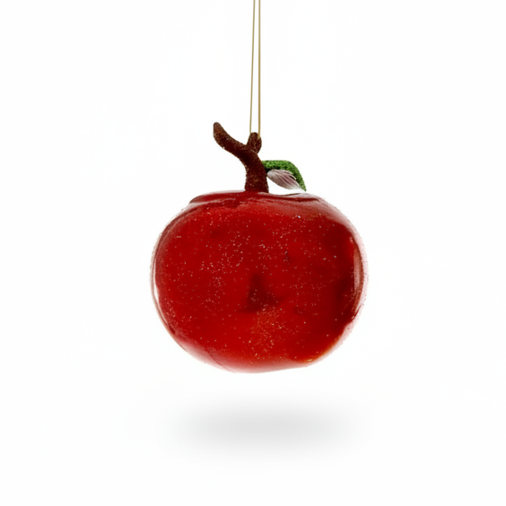 Red apple-shaped ornament with a branch on a white background