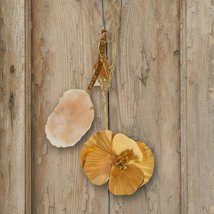 Gold n floral pendants on a wooden background