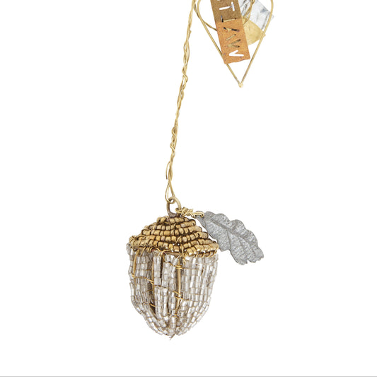 Decorative acorn ornament with a tag on a white background