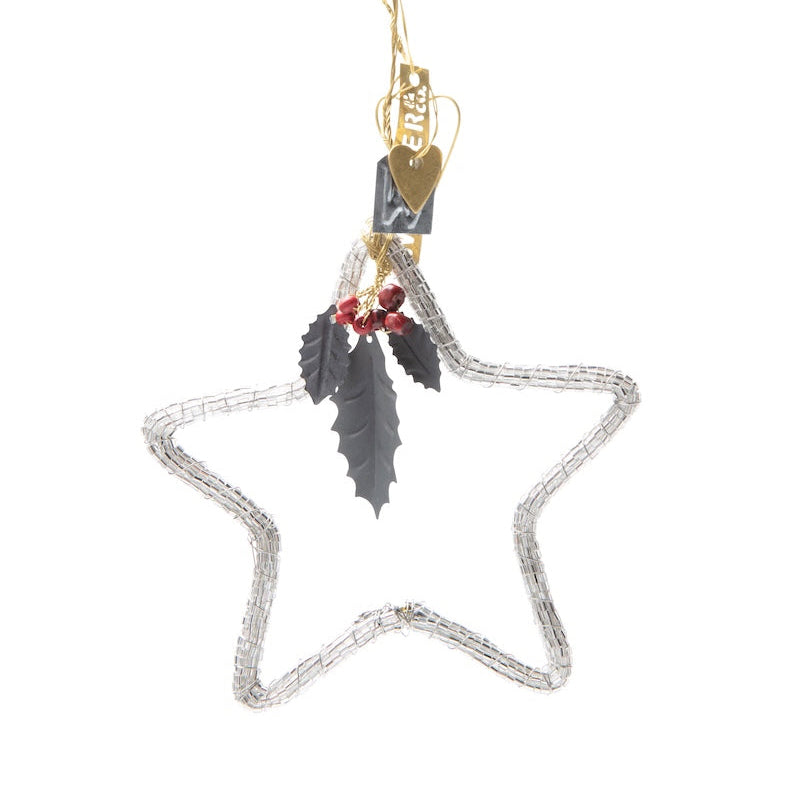 Decorative star ornament with feathers and berries on a white background