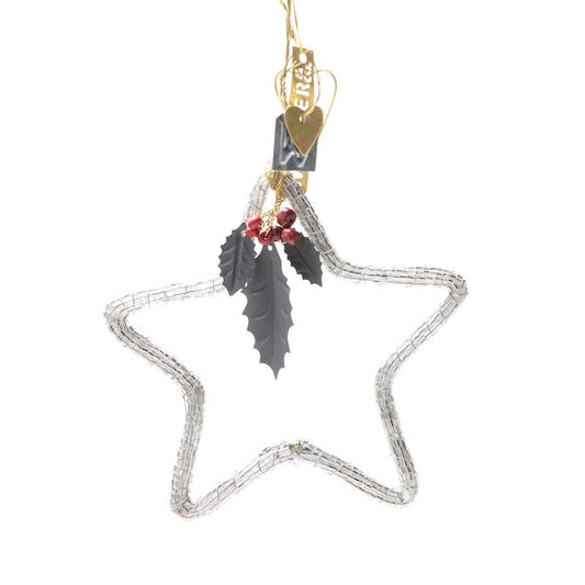 Decorative star ornament with feathers and berries on a white background