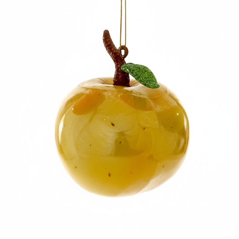 Decorative apple ornament with a branch and leaf on a white background